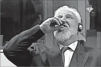  ?? [ICTY] ?? Slobodan Praljak drinks poison from a small bottle Wednesday in front of a Yugoslav war crimes tribunal in The Hague, Netherland­s. He died shortly after. Praljak drank from the bottle seconds after judges reconfirme­d his 20-year sentence for helping...