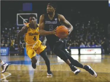  ?? The Associated Press ?? GUARDS: In this Feb. 22, file photo Buffalo guard CJ Massinburg (5) drives past Kent State guard Antonio Williams (4) during the second half of an NCAA college basketball game in Buffalo, N.Y.