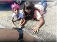  ?? AURORA POLICE DEPARTMENT VIA AP ?? In this image from police body cam video, Lovely Gilliam, 6, looks up as she and family members lie in a parking lot, in Aurora, Colo., on Aug. 2, 2020,