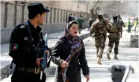  ?? (Omar Sobhani/Reuters) ?? AN AFGHAN WOMAN looks for her relative yesterday at the site of a suicide attack in Kabul.