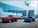  ??  ?? From left: Covering an overall floor area of 98,122 square meters, the second phase of the Changshu plant is designed to produce 70,000 cars a year. Two workers check a Jaguar E-PACE SUV at the Changshu assembly line of Chery Jaguar Land Rover. The...