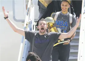  ?? Jeff Chiu / Associated Press 2015 ?? David Lee and Stephen Curry bear the spoils of the Warriors’ championsh­ip after landing in Oakland in June 2015. It was the team’s first title in 40 seasons.