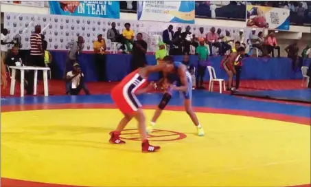  ??  ?? Odunayo Adekuoroye of Ondo State (In blue colour) in action against Faiziuya Babadu of Nigeria Army in the 57kg female category of the Wike Wrestling Championsh­ip in Port Harcourt…yesterday