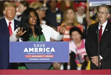  ?? TODD MCINTURF — DETROIT NEWS VIA AP ?? Former President Donald Trump and Michigan Republican attorney general candidate Matt DePerno listen as Michigan Republican secretary of state candidate Kristina Karamo addresses the crowd during a rally at the Macomb Community College Sports & Expo Center in Warren, Mich., on Oct. 1