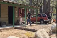  ?? Tracy Barbutes / Special to The Chronicle ?? Ryan Hansken and Jill Nestroyl return to their Sierra Tract South Lake Tahoe, California, home on Monday afternoon.