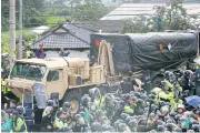  ?? EPA ?? Protesters attempt to block a US military vehicle carrying a Thaad missile defence system in Seongju, South Korea, yesterday.