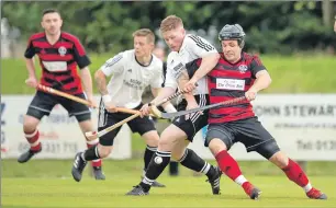  ?? Photograph: Neil Paterson. ?? Drew Howie and Daniel Cameron in a tussle for the ball during the Camanachd Cup semi-final at An Aird.