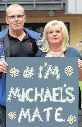  ?? Colin Lane ?? Michael’s parents Mike and Marie Causer at a vigil for their son in Liverpool city centre