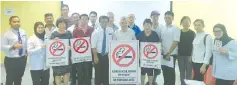  ??  ?? Rahman (fifth left) with staff and associatio­n members posing with the smoking-ban signage to be placed at eateries.