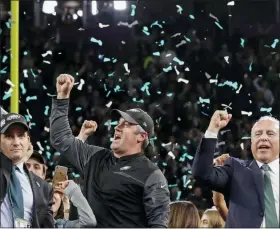  ?? ASSOCIATED PRESS FILE ?? In this file photo, Eagles general manager Howie Roseman, left, holds up the Vince Lombardi Trophy as he celebrates with head coach Doug Pederson and owner Jeffrey Lurie, right, after Super Bowl 52 in Feb. 2018. The Eagles are going to charge fans for their only training camp session open to the public, with the money going to their Eagles Autism Challenge.