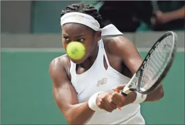  ?? Ap-kirsty Wiggleswor­th ?? United States’ Cori “Coco” Gauff returns the ball to Romania’s Simona Halep in a women’s singles match during day seven of the Wimbledon Tennis Championsh­ips in London on Monday.