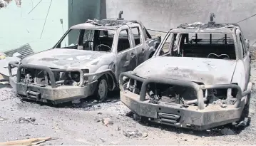  ?? REUTERS ?? Damaged army vehicles are seen here following a Taliban attack in Ghazni City, Afghanista­n.
