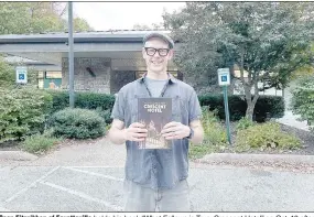  ?? (NWA Democrat-Gazette/Rachel Dickerson) ?? Sean Fitzgibbon of Fayettevil­le holds his book “What Follows is True: Crescent Hotel” on Oct. 18 after speaking at the Bella Vista Public Library.