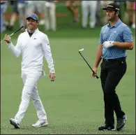  ?? AP/MATT SLOCUM ?? Rory McIlroy (left) and Jon Rahm are two players trying to keep Tiger Woods from winning the Masters this weekend in their attempt to win a first green jacket of their own.