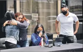  ?? Alejandro Tamayo San Diego Union-Tribune ?? REBOLLAR GOMEZ hugs her daughter, Karla Cruz, after speaking at a news conference Friday in Chula Vista. Her son, Army 1st Lt. Gibram Cruz, is at right.