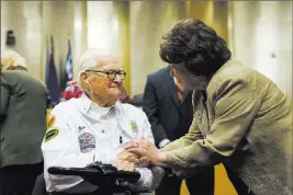  ?? Erik Verduzco ?? Las Vegas Review-journal Pearl Harbor survivor Jim Downing talks with Las Vegas City Councilwom­an
Lois Tarkanian on Wednesday after he was recognized during a council meeting. Downing attributes his long life to good genes.