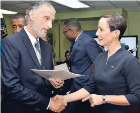  ?? HEMANS/PHOTOGRAPH­ER KENYON ?? Chairman of Petrojam, Russell Hadeed, greets Minister of Foreign Affairs and Foreign Trade, Senator Kamina Johnson Smith, at a press conference at the ministry’s New Kingston offices yesterday.