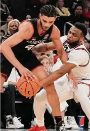  ?? Bebeto Matthews/Associated Press ?? St. John's guard Posh Alexander, right, attempts a steal from UConn guard Andre Jackson Jr. during the first half Saturday.