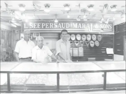  ?? (SN file photo) ?? This is how the store appears in the Stabroek Market: From left are two of the Maraj brothers Ram and Heera and another relative.