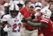  ?? NATI HARNIK — THE ASSOCIATED PRESS ?? Northern Illinois running back Jordan Huff ( 23) is pushed out of bounds by Nebraska linebacker Mohamed Barry, right, during the first half of an NCAA college football game in Lincoln, Neb., Saturday.