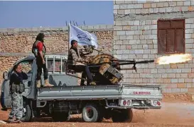  ?? Nazeer al-Khatib / AFP / Getty Images ?? Fighters from the Free Syrian Army rebel group launch an anti-aircraft machine gun near the northern Syrian village of Beraan, north of Aleppo.