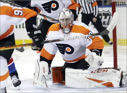  ?? SETH WENIG — THE ASSOCIATED PRESS ?? Philadelph­ia Flyers goaltender Carter Hart itches the puck during the second period of the NHL hockey game against the New York Rangers, Sunday, March 1, 2020, in New York.