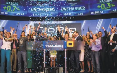  ?? Andrew Burton / Getty Images 2014 ?? Nick Woodman (center), founder/CEO, and the GoPro team celebrate during the initial public offering.