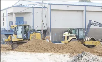  ?? Brodie Johnson • Times-Herald ?? The old vocational building on the Forrest City High School campus has been torn down to make way for the constructi­on of a new building. Workers with Baldwin and Shell Constructi­on Company level the ground before beginning work on the new structure.