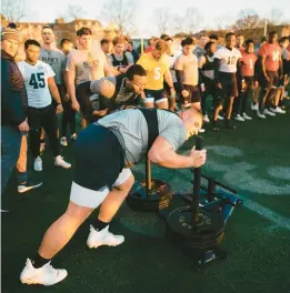  ?? COURTESY NAVY ATHLETICS ?? Offensive lineman Lirion Murtezi pushes a sled during one of Navy football’s infamous predawn “fourth quarter” workouts.