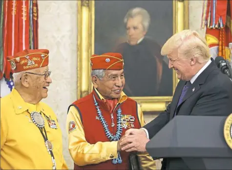  ?? Oliver Contreras-Pool/Getty Images ?? President Donald Trump greets members of the Native American code talkers Monday at the White House. Mr. Trump used “Pocahontas” as a pejorative directed at political adversary Sen. Elizabeth Warren during the event.