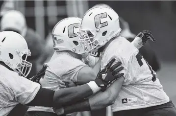  ?? STAFF FILE PHOTO BY DOUG STRICKLAND ?? Offensive lineman Harrison Moon, right, runs a drill with teammates during the UTC football team’s first spring practice at Scrappy Moore Field on Feb. 24. The former Signal Mountain star transferre­d from Mississipp­i State.