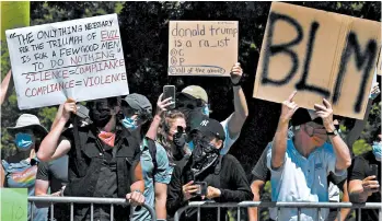  ?? NICHOLAS KAMM/GETTY-AFP ?? Protesters line the street near the Dallas campus of Gateway Church as President Donald Trump arrives Thursday for a roundtable discussion on race and policing efforts.