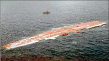  ?? MARINE NATIONALE ?? The cargo ship Tricolor lies on its side in the English Channel on Dec. 14, 2002, after a collision sank the vessel with 2,862 cars on board. The ship was eventually cut into pieces and removed.
