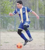  ?? Westside Eagle Observer/MIKE ECKELS ?? Andres Revolorio moves the ball downfield at Bulldog Stadium in Decatur March 30 during the DecaturEur­eka Springs conference match. The Bulldogs traveled to Green Forest April 13, taking on the Tigers in a conference showdown for first place in the 3A-1 race. The Tigers took the win, 4-1.