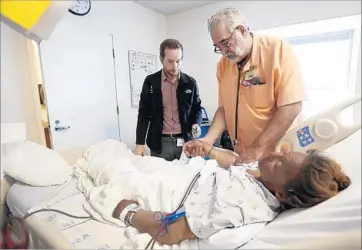  ?? Al Seib Los Angeles Times ?? COST-SHARING reduction payments, or CSRs, from the federal government help insurers cover low-income patients’ copayments and deductible­s. Here, doctors check a patient at L.A. County-USC Medical Center.