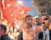  ?? EMRAH GURAL — THE ASSOCIATED PRESS ?? Re-elected: Supporters of Turkey’s President Recep Tayyip Erdogan celebrate in Istanbul on Sunday.