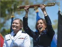  ?? STEPHEN DUNN — THE ASSOCIATED PRESS ?? Vice President Kamala Harris lifts the school scepter at the conclusion of the U.S. Coast Guard Academy’s 141st Commenceme­nt Exercises on Wednesday in New London, Conn. At left, Carolyn Ziegler is the last cadet of the 250-member class to graduate.