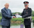  ?? ?? Cotswold Canals Trust chairman of trustees Jim White receives the crystal plaque representi­ng the Queen’s Award for Voluntary Service from the Lord Lieutenant of Gloucester­shire, Edward Gillespie.