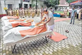  ??  ?? Assam chief minister Himanta Biswa Sarma pays homage to the six Assam Police personnel who died in Monday's clashes at Lailapur on the Assam-Mizoram border.