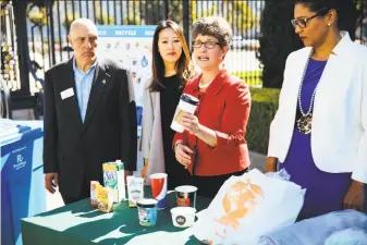  ?? Mason Trinca / Special to The Chronicle ?? Debbie Raphael, director of the city’s Department of the Environmen­t, details the items that are now accepted in the blue recycling bins, including used food containers and bubble wrap.