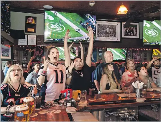  ?? Mel Melcon Los Angeles Times ?? NOTHING beats the excitement of another six points. At Sonny McLean’s in Santa Monica, Patriots fans Denise Nero, far left, Nikki Nero and Sam Speroni feel it.