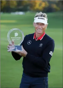  ?? DANIEL SANGJIB MIN — RICHMOND TIMES-DISPATCH VIA AP ?? Bernhard Langer holds his trophy after winning the Dominion Energy Charity Classic golf tournament at Country Club of Virginia on Sunday.