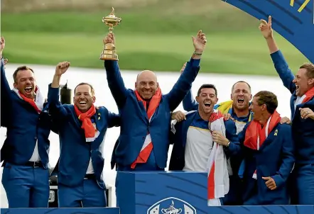 ?? MATT DUNHAM/AP ?? Europe team captain Thomas Bjorn holds aloft the Ryder Cup after his team beat the USA 171⁄2 to 101⁄2 at Le Golf National outside of Paris yesterday.