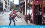  ?? ?? LONDON: A worker puts away chairs in London. BritHPU PZ PU YLJLZZPVU VMÄJPHS KH[H ZOV^LK ;O\YZKH` dealing another blow to embattled Prime Minister Rishi Sunak. — AFP