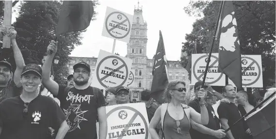  ?? THE CANADIAN PRESS/FILES ?? Demonstrat­ors with La Meute, the largest far-right organizati­on in Quebec, stage a protest in front of the legislatur­e in Quebec City last August, a week after a protester was killed at a Unite the Right rally in Charlottes­ville, Va. A group of...