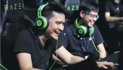  ?? PROVIDED TO CHINA DAILY ?? Min-Liang Tan (left) participat­es in an esports competitio­n on May 22 in Beijing.