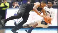  ?? Jessica Hill / Associated Press ?? UConn’s Alterique Gilbert, right, fouls UCF’s BJ Taylor during the second half on Saturday.