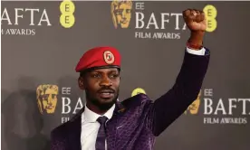  ?? Adrian Dennis/AFP/Getty ?? Bobi Wine at this month’s Bafta film awards in London. Moses Bwayo, director of Bobi Wine: The People’s President, says the police withdrew from Wine’s home, where the family had been under house arrest, when the Oscars nomination was announced. Photograph: