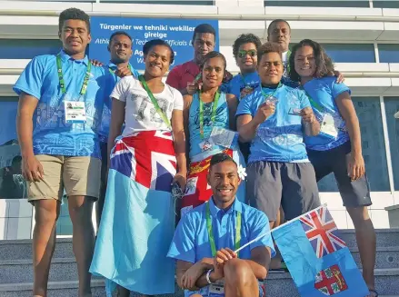  ?? Photo: FASANOC ?? Team Fiji weightlift­er Apolonia Vaivai (middle row, second from right), with members of Team Fiji in Ashgabat, Turkmenist­an, on September 23, 2017.