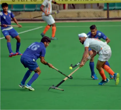  ??  ?? Action from a pool match between National Hockey Academy and Indian Navy in New Delhi on Sunday.